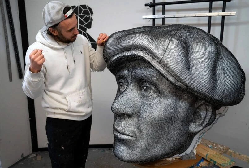 Ben Koracevic in his studio working on a large string art portrait